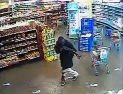 FILE- A gunman aims his rifle inside a store during an attack on the Westgate shopping mall in this still frame taken from video footage by security cameras in Nairobi, Kenya, and released to Reuters on Oct. 17, 2013.