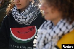 FILE - A woman wears a shirt with an image of watermelon during a pro-Palestinian protest in Gaza, in Amman, Jordan, December 22, 2023.