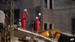 Rescuers search for victims at the site of an Israeli airstrike that targeted a building in Beirut, Lebanon, Nov. 26, 2024.