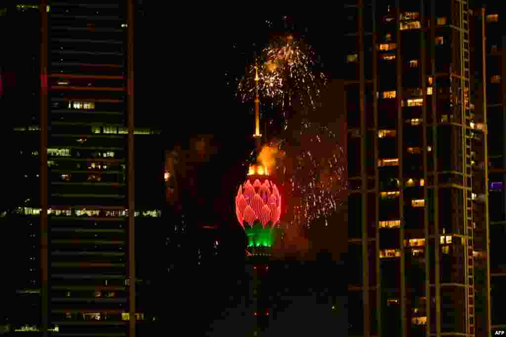 Fireworks explode next to the Lotus Tower during New Year's Eve celebrations in Colombo, Sri Lanka, Jan. 1, 2025.