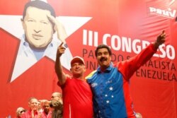 FILE - Venezuela's President Nicolas Maduro, right, embraces retired General Hugo Carvajal as they attend the Socialist party congress in Caracas, July 27, 2014.