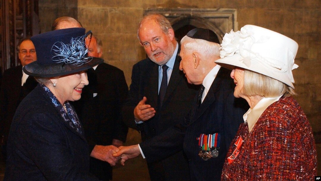 FILE - Britain's Queen Elizabeth II, left, meets Holocaust survivor Gena Turgel during a service to remember victims of the Holocaust in Westminster Central Hall in London on the 60th anniversary of the liberation of Auschwitz, Jan. 27, 2005. Turgel, who comforted diarist Anne Frank at the Bergen-Belsen concentration camp months before its liberation, has died. She was 95. 