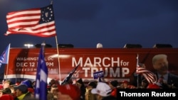 People take part in an event to show their support for U.S. President Donald Trump in Macomb County, Michigan