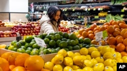 A woman browses produce for sale at a Whole Foods grocery store, Friday, Jan. 19, 2024, in New York. (AP Photo/Peter K. Afriyie)