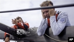 Skipper Ken Read from the USA, right, reacts to a broken mast on the first leg of the Volvo Ocean Race, Nov. 21, 2011.