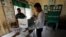 Election workers assemble a polling booth inside a classroom at a school in Phnom Penh, Cambodia, July 28, 2018. Cambodians head to the polls Sunday.