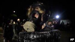 A protester wearing a gas mask is seen during the nightly protests in downtown Portland, Oregon, Aug. 30, 2020.