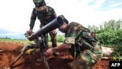 This photo taken on July 3, 2024 shows members of ethnic minority armed group Ta'ang National Liberation Army (TNLA) preparing their weapons amid clashes with Myanmar's military in Kyaukme in Myanmar's northern Shan State.