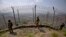 FILE - Pakistan Army troops patrol along the fence on the Pakistan-Afghanistan border at Big Ben hilltop post in Khyber district, Pakistan, Aug. 3, 2021.