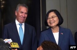 Taiwan's President Tsai Ing-wen talks to the press along with USTBC chairman/NASDAQ president Michael Splinter before they attend a Taiwan-US business summit organized by USTBC and Taiwan's trade organization TAITRA in New York July 12, 2019.