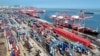 FILE - Shipping containers and gantry cranes are seen at a port in Lianyungang, in eastern China's Jiangsu province on Aug. 7, 2024.