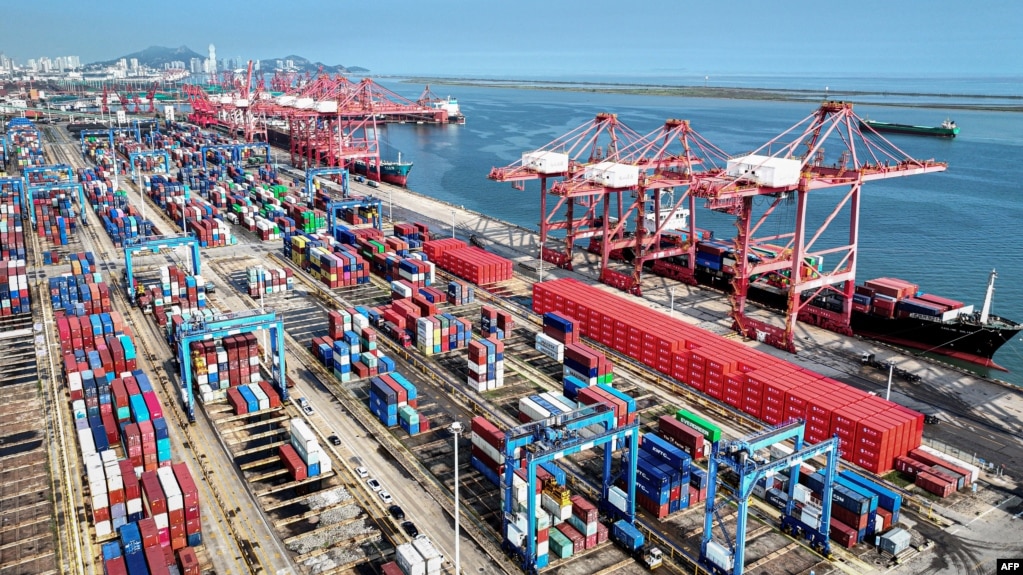 FILE - Shipping containers and gantry cranes are seen at a port in Lianyungang, in eastern China's Jiangsu province, on Aug. 7, 2024.