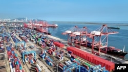 FILE - Shipping containers and gantry cranes are seen at a port in Lianyungang, in eastern China's Jiangsu province, on Aug. 7, 2024.