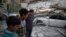 Children are seen near rubble after an airstrike in the besieged town of Douma, in eastern Ghouta, near Damascus, Syria, Feb. 6, 2018.