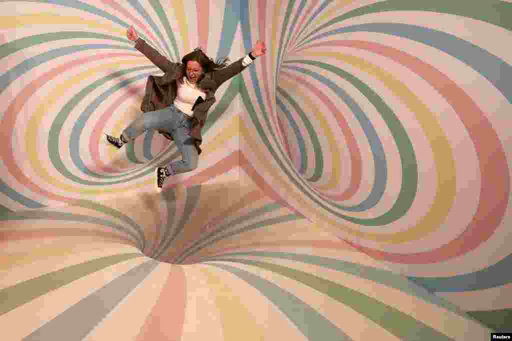 A girl poses for a photo during a visit to the Instagram museum &quot;Smile Safari&quot; that recently opened in Brussels, Belgium.