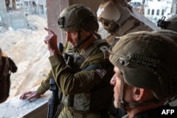 This photo released by the Israeli army on Oct. 17, 2024, shows the Chief of the General Staff Lieutenant-General Herzi Halevi, left, and the head of the Israeli Security Agency, Ronen Bar, visiting what the army says is the location where Hamas leader Yahya Sinwar was killed.