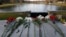 Flowers honoring the victims that died a day earlier when a gunman opened fire at an elementary school lay on a bridge in Newtown, Conn., Dec. 15, 2012. 