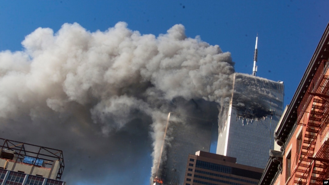 FILE - Smoke rises from the burning twin towers of the World Trade Center after hijacked planes crashed into them, in New York City, Sept. 11, 2001. 