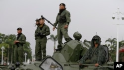 Venezuela CrisisSoldiers stand atop an armored vehicle at the entrance of Fort Tiuna in Caracas, Venezuela, Aug. 26, 2017. 