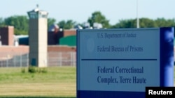FILE - Signage is seen at a federal correctional complex in Terre Haute, Indiana, July 13, 2020.