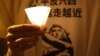 A man wears a T-shirt with Chinese reading "Vindicate June 4" at a candlelight vigil at Hong Kong's Victoria Park in Hong Kong Monday June 4, 2012 to mark the 23rd anniversary of the Chinese military crackdown on the pro-democracy movement in Beijing. 