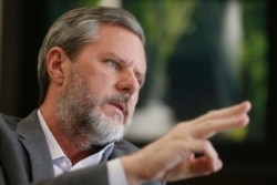 FILE - Liberty University President Jerry Falwell Jr. gestures during an interview in his offices at the school in Lynchburg, Va., Nov. 16, 2016.
