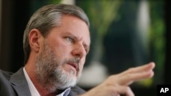 FILE - Liberty University President Jerry Falwell Jr. gestures during an interview in his offices at the school in Lynchburg, Va., Nov. 16, 2016. 