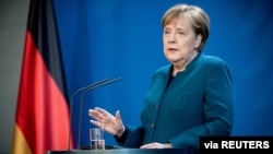 FILE - German Chancellor Angela Merkel gives a media statement on the spread of the new coronavirus disease (COVID-19) at the Chancellery in Berlin, Germany, March 22, 2020. 