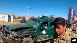 Afghan police inspect the site of a suicide attack, in Parwan province of Afghanistan, Sept. 17, 2019.