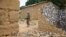 FILE -  A United Nations peacekeeper stands among houses destroyed by violence in the abandoned village of Yade, Central African Republic, April 27, 2017.