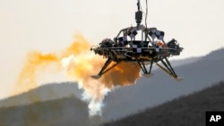 A lander is lifted during a test of hovering, obstacle avoidance capabilities in China's Hebei province, Thursday, Nov. 14, 2019. 
