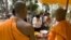 FILE - Cambodian Buddhist monks bless to Buddhist followers near Bayon temple in Siem Reap province, about 320 kilometers (199 miles) north of Phnom Penh, Cambodia, Tuesday, April 27, 2010.