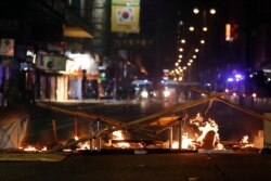 Debris burns on a street during a rally in Hong Kong, Dec. 25, 2019.