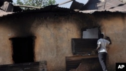 A man inspect a burnt out house following an attacked by gunmen in Bokkos, north central Nigeria, Tuesday, Dec. 26, 2023.