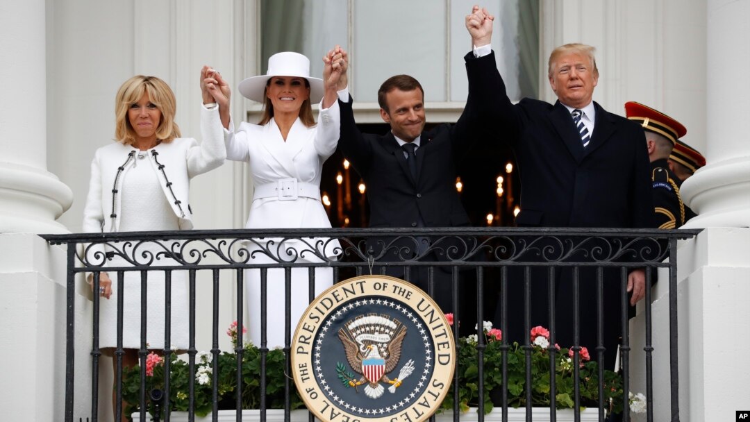 President Donald Trump, French President Emmanuel Macron, first lady Melania Trump and Brigitte Macron hold hands on the White House balcony during a State Arrival Ceremony at the White House in Washington, April 24, 2018. 