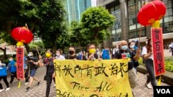 社民连主席黃浩铭（手持麦克风者）与3名成员7月1日早上遊行，呼吁中共毋忘建党初心，实行普选，释放所有政治犯 （美国之音汤惠芸）