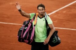 FILE - Spain's Rafael Nadal waves to the crowd after losing to Serbia's Novak Djokovic in their semifinal match of the French Open tennis tournament at the Roland Garros stadium in Paris, June 11, 2021.