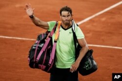 FILE - Spain's Rafael Nadal waves to the crowd after losing to Serbia's Novak Djokovic in their semifinal match of the French Open tennis tournament at the Roland Garros stadium in Paris, June 11, 2021.