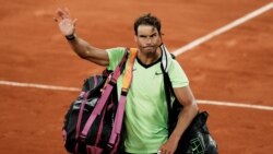 FILE - Spain's Rafael Nadal waves to the crowd after losing to Serbia's Novak Djokovic in their semifinal match of the French Open tennis tournament at the Roland Garros stadium in Paris, June 11, 2021.