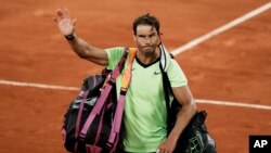 FILE - Spain's Rafael Nadal waves to the crowd after losing to Serbia's Novak Djokovic in their semifinal match of the French Open tennis tournament at the Roland Garros stadium in Paris, June 11, 2021. 