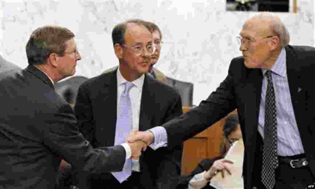 Debt Commission member, Senate Budget Committee Chairman Sen. Kent Conrad, D-N.D., left , shakes hands with co-chairmen former Wyoming Sen. Alan Simpson, right, as fellow co-chairmen Erskine Bowles, looks on at center, after a meeting of the commission on