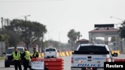 Police officers stand at a checkpoint after a shooting incident at Naval Air Station Corpus Christi, Texas, May 21, 2020. 