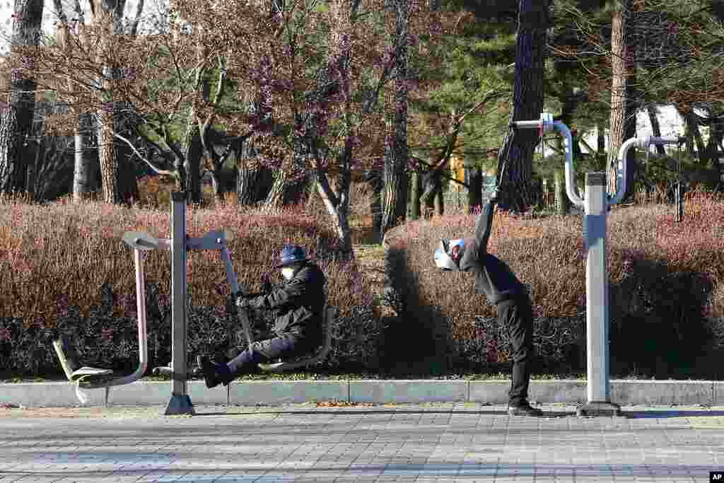 People wearing face masks as a precaution against the coronavirus exercise at a park in Goyang, South Korea.