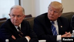 FILE - Donald Trump sits with U.S. Senator Jeff Sessions, R-Ala., at Trump Tower in Manhattan, New York, Oct. 7, 2016. 