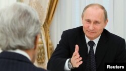FILE - Russian President Vladimir Putin, right, speaks with U.S. Secretary of State John Kerry in the Kremlin in Moscow, May 7, 2013.