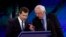 Democratic presidential candidates South Bend Mayor Pete Buttigieg, left, and Sen. Bernie Sanders talk during a break, Sept. 12, 2019, during a Democratic presidential primary debate in Houston.