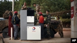 French soldiers fill up their tank at a local petrol station in Sevare, some 620 kilometers (385 miles) north of Mali's capital Bamako, Jan. 25, 2013. 