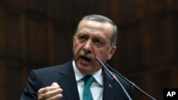 Turkey's Prime Minister Recep Tayyip Erdogan addresses his supporters at the parliament in Ankara, Turkey, Jan. 14, 2014. 