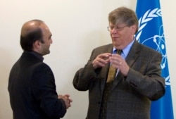 FILE - Olli Heinonen, deputy director of the U.N. International Atomic Energy Agency, speaks with Javad Vaeedi, left, Iran's deputy nuclear negotiator in Tehran, Oct. 29, 2007.