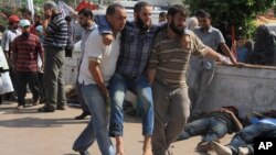 An injured man is brought to a makeshift hospital after Egyptian soldiers and police opened fire on supporters of the ousted President Mohammed Morsi early Monday in Cairo, Egypt, July 8 , 2013.
